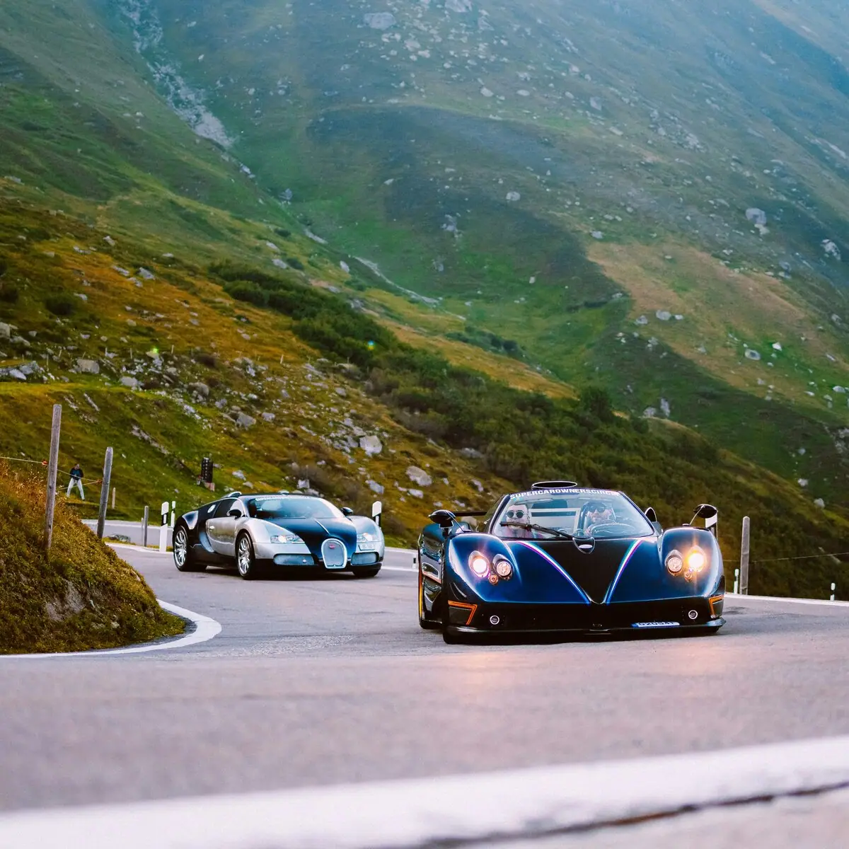 Two supercars parked on a mountain pass