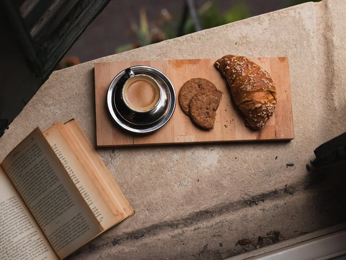 Paper road map and coffee on a table during trip planning